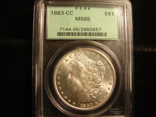 1883 - Cc Morgan Silver Dollar,  Graded By Pcgs Ms65,  In Ogh,  As Pictured.