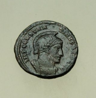Constantine I (307 - 337).  Helmeted Cuirased Bust Ae 18mm Ticinum.  Two Victories
