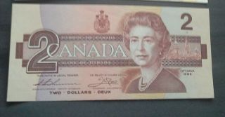 1986 - 1973.  $2 Canada Note - Canadian Two Dollar Bill - And One Dollar Bill,