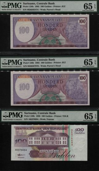 Tt Pk 128b & 139b 1985 & 1998 Suriname 100 Gulden Pmg 65 Epq Gem Unc Set Of 3