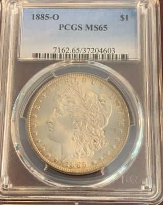 1885 - O Morgan Dollar Pcgs Graded Ms65.  Turning Gold Around The Edges