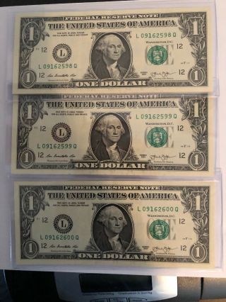 3 One Dollar Bills In Sequence With The Number (1) Over Inked