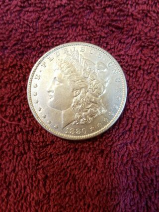 1880 - O Morgan silver dollar in AU.  505 2