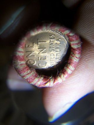 WHEAT PENNY ROLL WITH A UNKNOWN BU WHEAT PENNY SHOWING 2