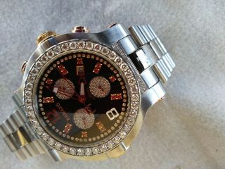 RENATO MENS DIAMOND AND RUBY WRIST WATCH.  WILD BEAST STEEL AND MOTHER OF PEARL. 10