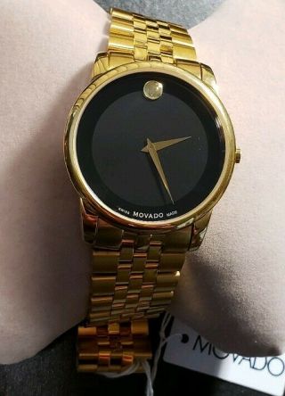 Movado Museum Classic Watch With 40mm Black Face & Golden Breclet.