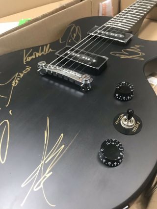 Matte black electric guitar autographed by Breaking Benjamin Rock Band. 6