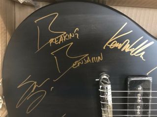 Matte black electric guitar autographed by Breaking Benjamin Rock Band. 7