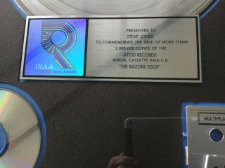 AC/DC “razor’s edge.  RIAA award for 2,  000,  000 sales of lp,  cd & cass 2