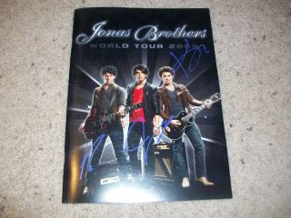The Jonas Brothers Signed 2009 World Tour Program W/proof Autograph