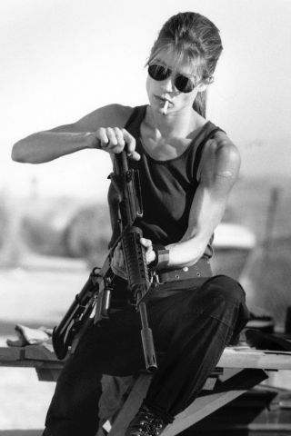 Terminator 2 Linda Hamilton As Sarah Connor With Cigarette Loading Gun Poster