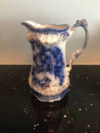 Flow Blue Tall Pitcher With Gold And Fancy Handle