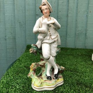 19thc Staffordshire Porcellaneous Male Figure Holding A Dog C1880s