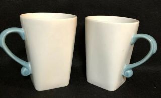 Two (2) Corelle Coordinates Porcelain Mugs.  White - Light Blue Handles.  Square 4.  5”