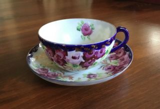 Tea Cup And Saucer In Vibrant Blue And Pink Roses
